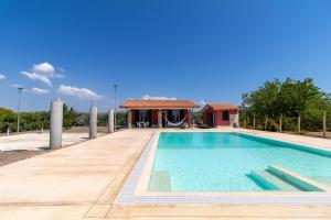 a villa with a swimming pool and a house at Villa Verde Oliva in Ispica