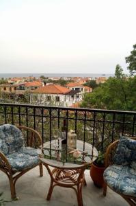 a table and chairs on a balcony with a view at Pygolampida Studios in Mytilini