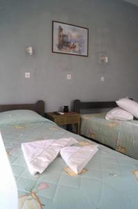 two beds sitting next to each other in a room at Pygolampida Studios in Mytilene