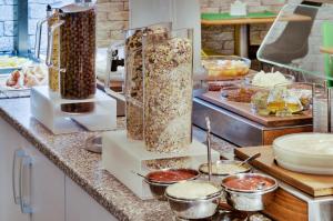 a kitchen counter with two containers of food at Adeba Plus in Prague