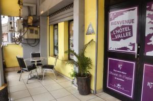 a restaurant with a table and chairs outside of it at HOTEL DE LA VALLEE NEW in Yaoundé