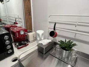 a kitchen counter with a red coffee maker on it at INC apartment in villa in Bucharest +12 photos