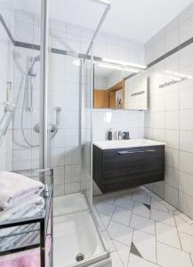 a bathroom with a shower and a sink at Appartements Allmaier in Pörtschach am Wörthersee