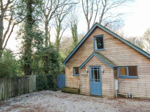 a house with a blue door and a fence at Grove Lodge in Penzance