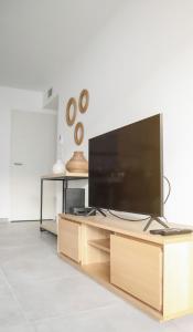 a living room with a large flat screen tv at T3 30 dans résidence neuve près des plages in Saint-Cyr-sur-Mer
