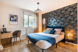 um quarto com uma cama, uma secretária e uma janela em Le Nouveau Monde - Appartement Chic et Confortable em Saint-Priest
