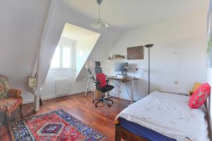 a bedroom with a bed and a desk and a chair at Belvedere de la Rance - Maison pour 6 avec jardin in Dinan