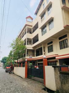 a tall building with a fence in front of it at Raga Homestay 2BHK- A homely guesthouse experience in Guwahati