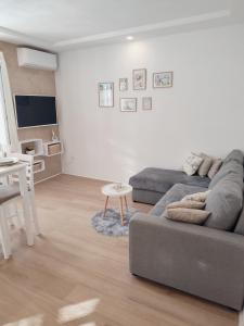 a living room with a couch and a table at Apartment Making memories in Pučišća