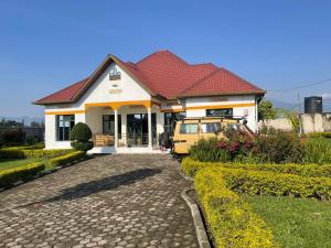 a yellow van parked in front of a house at Virunga House in Ruhengeri