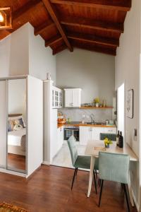 a kitchen with a table and chairs and a bedroom at Blerina Farm House in Laknas