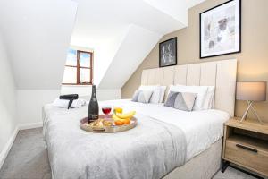 a bedroom with a bed with a tray of fruit on it at 4 Bedroom Detached House - Central MK - Free Parking, Fast Wifi and Smart TVs with Sky TV and Netflix by Yoko Property in Milton Keynes