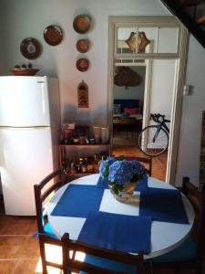 a table with a blue and white table cloth and a refrigerator at Ribeira da Praia House in Vila Franca do Campo