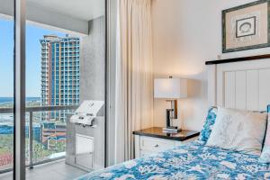 a bedroom with a bed and a view of a city at Portofino 4-1002 in Pensacola Beach