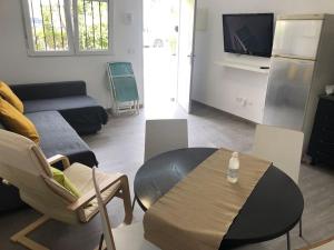 a living room with a table and a couch at La Carihuela Apartamento in Torremolinos