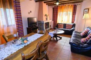 a living room with a table and a fireplace at Casas Rurales Trefacio in Trefacio