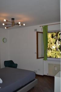 una camera da letto con un letto e una finestra con una tenda verde di 1Dest - Green Spot a Riva del Garda Altre 4 foto