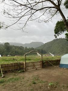 a fence with a view of a field at Manariwa - Exclusive Camp site in Tanay