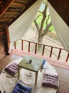 a room with a table and a view of a tree at Manariwa - Exclusive Camp site in Tanay