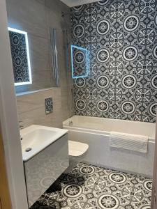 a bathroom with a sink and a toilet and a shower at Boutique Luxury Apartment, High St, Henley-in-Arden in Henley in Arden