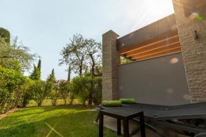 a ping pong table in the backyard of a house at Lamasu RioVerde - Lago di Garda in San Felice del Benaco