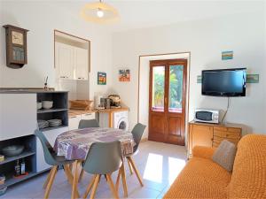 a living room with a table and a kitchen at La Maggiolina in Baveno