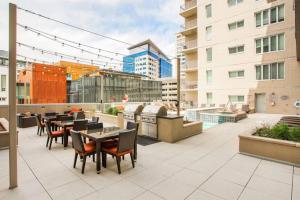 a rooftop patio with tables and chairs on a building at LoDo 1BR w WD Pool Gym nr Union Station DEN-152 in Denver