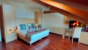 a bedroom with a bed and a fireplace at Savoia Resort in Bardonecchia