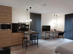 a room with two tables and a bed and a television at Urbs Amiens Sud in Amiens