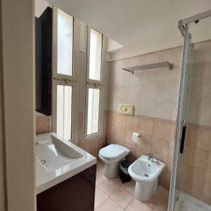 a bathroom with a sink and a toilet and a shower at La terrazza di nonno Ciccio in Monopoli