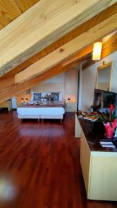 a large room with a bed and a desk at Savoia Resort in Bardonecchia
