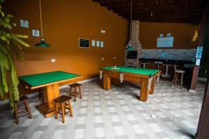 a room with two ping pong tables and a bar at Pousada Filhos da Terra in Trindade