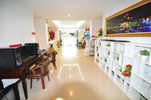 a room with a pharmacy with a large monitor on the wall at Man u Apartment in Chaiyaphum