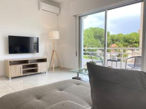 a living room with a couch and a television at Phaedrus Living Down Town Flat Nestoras 301 in Limassol