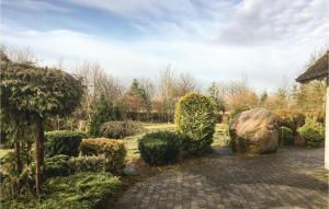 a garden with a stone path and a large rock at 4 Bedroom Pet Friendly Home In Brande in Brande