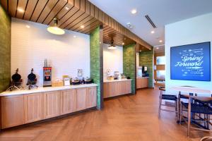 a restaurant with a counter and a table and chairs at Fairfield Inn & Suites by Marriott Dallas Cedar Hill in Cedar Hill