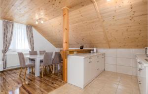 a kitchen and dining room with a table and chairs at Cozy Home In Debelo Brdo I With Wifi in Debelo Brdo