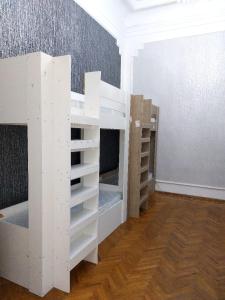 two white bunk beds in a room with a wall at A & F HOSTEL in Baku