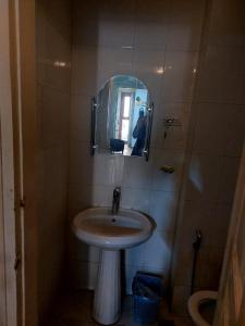 a bathroom with a sink and a mirror at A & F HOSTEL in Baku