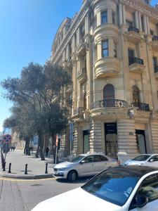 a building with cars parked in front of it at A & F HOSTEL in Baku