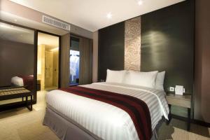 Postel nebo postele na pokoji v ubytování Aston Priority Simatupang Hotel and Conference Center