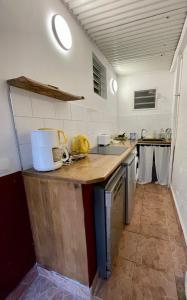 a kitchen with a wooden counter top in a room at plage et spot de surf in Le Gosier