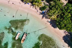 two boats in the water on a beach at plage et spot de surf in Le Gosier