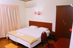 Posteľ alebo postele v izbe v ubytovaní Hotel Srinivas