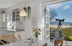 a kitchen with a table and a view of the ocean at 3 Bedroom Gorgeous Home In Broager in Broager
