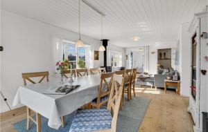a dining room and living room with a table and chairs at 3 Bedroom Gorgeous Home In Broager in Broager