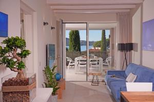 a living room with a blue couch and a table at Lamasu RioVerde - Lago di Garda in San Felice del Benaco
