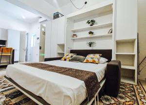 a bedroom with a large bed with pillows on it at Entire Studio Apartment in Sliema 2A By Solea in Sliema