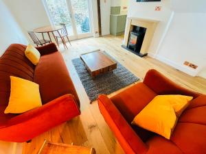 a living room with a couch and a table at Abbey Gardens Cottage in Bury Saint Edmunds