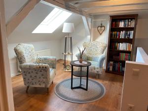 - un salon avec deux chaises et une table dans l'établissement Altstadt Apartment Augustiner, à Erfurt